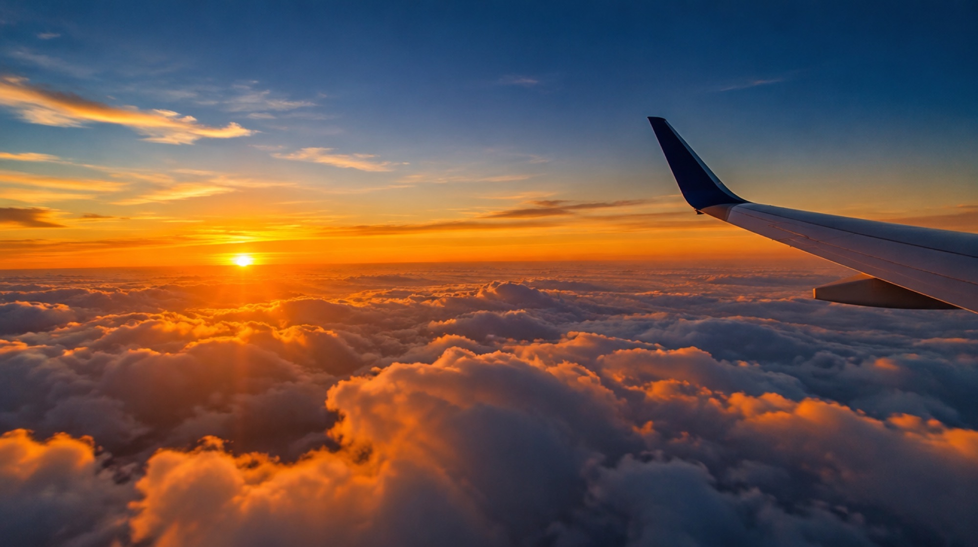 Sunrise over clouds seen from an aircraft window